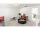 Bright playroom featuring a comfortable gray sofa, a small table, and a stylish wood entertainment center at 4412 Beckel Rd, Willow Springs, NC 27592
