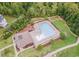 Aerial view of community pool with lap lanes, lounge chairs, and a clubhouse surrounded by trees at 50 Dover Ridge Ct, Chapel Hill, NC 27517