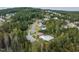 Beautiful aerial view of community pool and clubhouse surrounded by lush greenery and single-Gathering homes at 50 Dover Ridge Ct, Chapel Hill, NC 27517