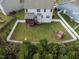 Aerial view of a fenced backyard with a playset, lush green grass, and screened porch at 50 Dover Ridge Ct, Chapel Hill, NC 27517