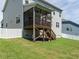A backyard with a screened porch, green lawn, and white picket fence at 50 Dover Ridge Ct, Chapel Hill, NC 27517