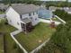 Aerial view of a backyard with a swing set, patio, and white fence at 50 Dover Ridge Ct, Chapel Hill, NC 27517