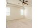 Spacious bedroom with neutral walls and carpet, featuring a modern ceiling fan and natural light from windows at 50 Dover Ridge Ct, Chapel Hill, NC 27517