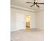 Bright bedroom with ceiling fan, a door to the bathroom, and neutral walls and carpet at 50 Dover Ridge Ct, Chapel Hill, NC 27517