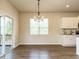 Bright dining area with hardwood floors, stylish chandelier, and sliding glass doors to the outdoor living area at 50 Dover Ridge Ct, Chapel Hill, NC 27517