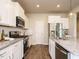 Well-equipped kitchen with stainless steel appliances, granite countertops, a center island, and sleek white cabinets at 50 Dover Ridge Ct, Chapel Hill, NC 27517