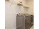 Convenient laundry room with modern washer and dryer, wire shelving, and ample storage space at 50 Dover Ridge Ct, Chapel Hill, NC 27517