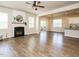 Open-concept living room with a fireplace, hardwood floors, and sliding glass doors leading to outdoor living at 50 Dover Ridge Ct, Chapel Hill, NC 27517