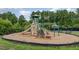 Community playground with slide, monkey bars, and benches surrounded by a secure black fence at 50 Dover Ridge Ct, Chapel Hill, NC 27517
