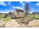 Backyard featuring a storage shed, fire pit, and stone patio at 500 Wakefield Dr, Princeton, NC 27569