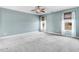 Spacious bedroom with a ceiling fan, carpet floors, two windows, and natural lighting at 500 Wakefield Dr, Princeton, NC 27569