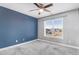 Well-lit bedroom with neutral carpet, light-grey walls, a ceiling fan, and a window at 500 Wakefield Dr, Princeton, NC 27569