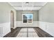 Dining room featuring wood-look flooring, white wainscoting, and a large window at 500 Wakefield Dr, Princeton, NC 27569