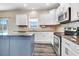 Bright kitchen with white cabinets, stainless steel appliances, granite countertops, and center island at 500 Wakefield Dr, Princeton, NC 27569