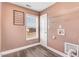 Well-lit laundry room with vinyl flooring, storage racks, and window at 500 Wakefield Dr, Princeton, NC 27569