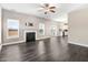 Spacious living room with dark wood floors, a fireplace, and two large windows with sliding glass doors at 500 Wakefield Dr, Princeton, NC 27569