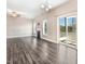 Bright living room with dark wood floors, a fireplace, and a sliding glass door leading to an outdoor space at 500 Wakefield Dr, Princeton, NC 27569