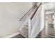 Carpeted stairway with white risers, wooden handrail, and natural light from a window at the top of the stairs at 500 Wakefield Dr, Princeton, NC 27569
