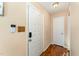 Foyer with a white door, security system, and a wood-look floor at 5816 Pointer Dr # 102, Raleigh, NC 27609