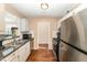 Bright kitchen features stainless steel appliances, white cabinetry, and a stainless steel double-basin sink at 5816 Pointer Dr # 102, Raleigh, NC 27609