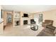 Open living room with a fireplace, built-in shelving, and sliding glass doors to the balcony at 5816 Pointer Dr # 102, Raleigh, NC 27609