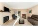 Cozy living room with fireplace, comfortable seating, and a glass top coffee table at 5816 Pointer Dr # 102, Raleigh, NC 27609