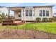 Back yard featuring a green lawn, a wooden deck, and mature trees at 5910 Lacebark Ln, Durham, NC 27713