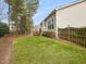 Expansive lawn wraps around the back of the house, accented by mature trees and a wood deck at 5910 Lacebark Ln, Durham, NC 27713