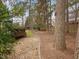 Backyard featuring mature trees and a brown wood deck at 5910 Lacebark Ln, Durham, NC 27713