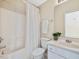 Bright bathroom features a tub and shower combo, toilet, and vanity sink with storage at 5910 Lacebark Ln, Durham, NC 27713