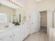 Bright bathroom with a double sink vanity and access to a walk in closet at 5910 Lacebark Ln, Durham, NC 27713