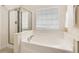 Modern bathroom featuring a soaking tub and glass enclosed shower at 5910 Lacebark Ln, Durham, NC 27713