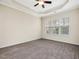Spacious bedroom featuring plush carpet, trey ceiling, and large windows for natural light at 5910 Lacebark Ln, Durham, NC 27713
