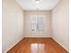 Cozy bedroom with a large window and hardwood floors, offering natural light and a warm atmosphere at 5910 Lacebark Ln, Durham, NC 27713