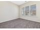 Neutral bedroom with three windows and carpeted flooring at 5910 Lacebark Ln, Durham, NC 27713