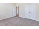 Large bedroom with double closets and an open doorway to another room at 5910 Lacebark Ln, Durham, NC 27713