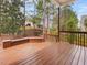 Outdoor wooden deck with built-in seating and a backyard view perfect for gatherings at 5910 Lacebark Ln, Durham, NC 27713