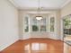 Inviting dining area featuring large windows and a sliding glass door for natural light at 5910 Lacebark Ln, Durham, NC 27713