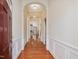Inviting entryway featuring hardwood floors, decorative molding, archways, and natural light at 5910 Lacebark Ln, Durham, NC 27713
