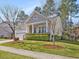 Charming single Gathering home featuring manicured lawn, stone accents, covered porch, and attached two-car garage at 5910 Lacebark Ln, Durham, NC 27713