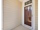 The home's front door offers a secure glass storm door at 5910 Lacebark Ln, Durham, NC 27713