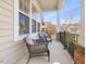 Cozy covered porch with comfortable seating, iron railings, and stone trim at 5910 Lacebark Ln, Durham, NC 27713