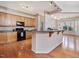 Bright kitchen showcasing modern appliances, wood cabinets, and a granite countertop bar at 5910 Lacebark Ln, Durham, NC 27713