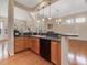 Kitchen with bar seating area that connects to the great room with natural light and modern appliances at 5910 Lacebark Ln, Durham, NC 27713