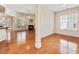 Open concept living space featuring hardwood floors, bright windows, fireplace and decorative columns at 5910 Lacebark Ln, Durham, NC 27713
