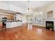Open-concept living space featuring hardwood floors, fireplace, and seamless flow to the kitchen at 5910 Lacebark Ln, Durham, NC 27713