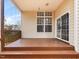 Covered porch featuring wood decking, offering a cozy outdoor living space at 5910 Lacebark Ln, Durham, NC 27713