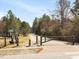 Paved trail through a wooded park area with a gate for added security at 5910 Lacebark Ln, Durham, NC 27713