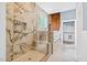 Luxurious bathroom featuring a marble shower, a soaking tub, and designer finishes at 601 Lee St, Durham, NC 27701