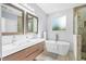 Elegant bathroom boasting double sinks, a soaking tub, and a separate shower for a spa-like experience at 601 Lee St, Durham, NC 27701